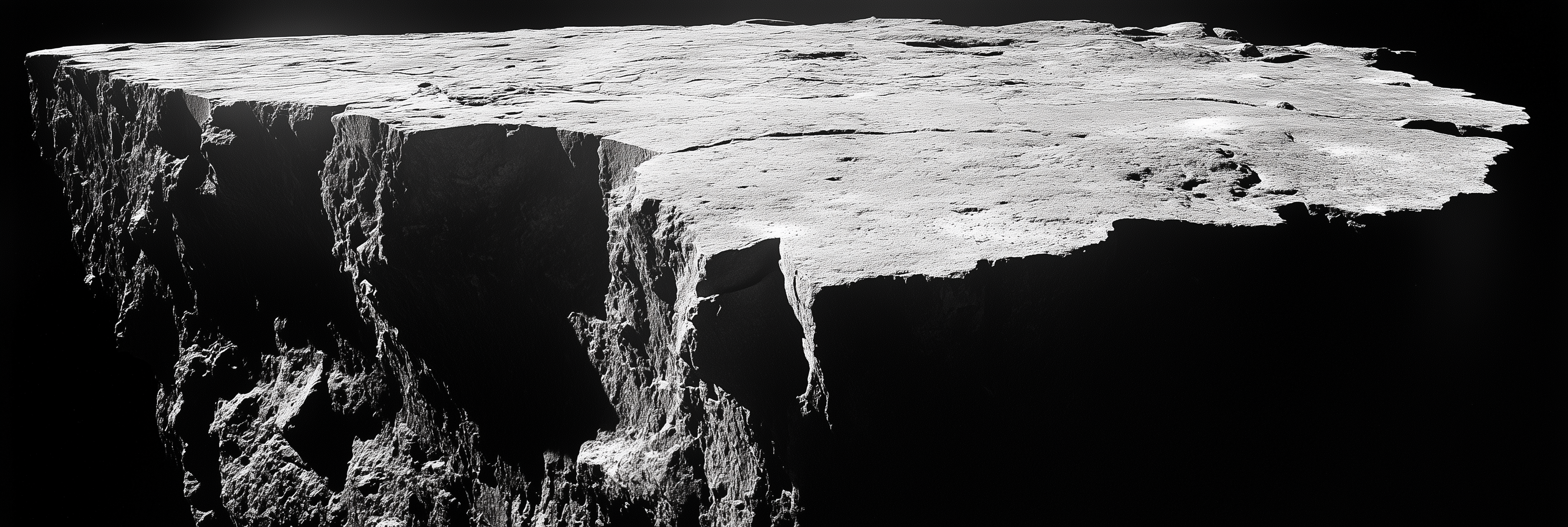 Black and white image of a large rock formation